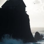 Free mobile wallpaper of house on cliff.